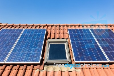 Blue Solar Collectors And Attic Window Stock Photo