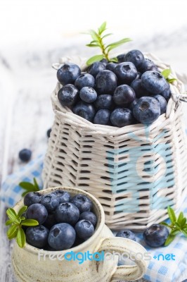Blueberry Basket And Jug On White Wooden Table Stock Photo