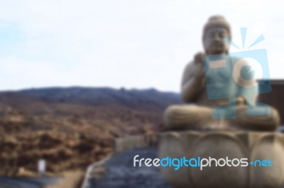Blurred Abstract Background Of Buddha Located In The Hills Stock Photo