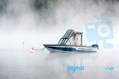 Boat Moored In Lake Mcdonald Stock Photo