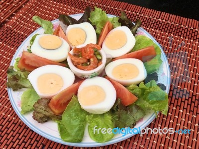 Boiled Egg Yolk With Tomato And Lettuce Served With Fish And Chili Sauce Stock Photo