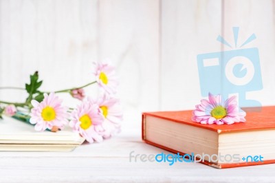 Books Or Journal With Flowers Arranged On A Neutral White Painted Desk Stock Photo