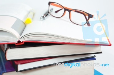 Books Stack With Open Book And Glasses Stock Photo
