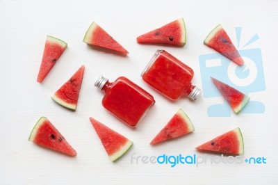 Bottle Of Fresh Watermelon Juice With  Watermelon Pieces  On Whi… Stock Photo