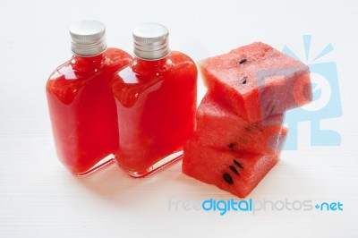 Bottle Of Fresh Watermelon Juice With  Watermelon Pieces  On Whi… Stock Photo