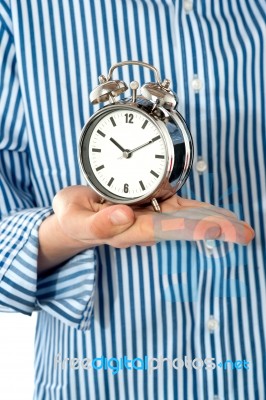 Boy Hand Holding Alarm Clock Stock Photo