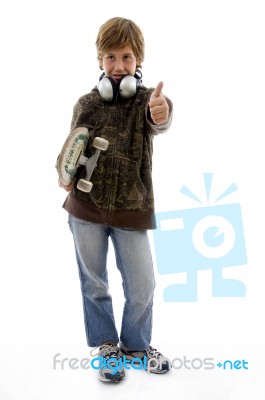 Boy Holding Skateboard And Showing Thumbs Up Stock Photo