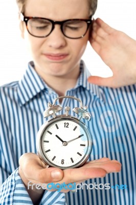 Boy Irritated With Noise Alarm Stock Photo