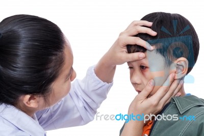 Boy With An Injured Eye. Doctor Examining And First Aid A Patient Injured On Left Eye Bruise Stock Photo