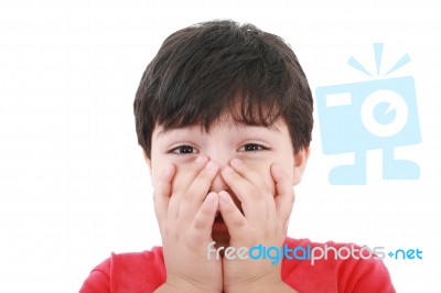 Boy With His Hands Over His Mouth Stock Photo