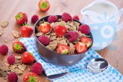 Bran Flakes With Fresh Raspberries And Strawberries And Pitcher Stock Photo