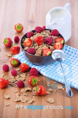 Bran Flakes With Fresh Raspberries And Strawberries And Pitcher Stock Photo
