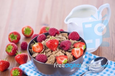 Bran Flakes With Fresh Raspberries And Strawberries And Pitcher Stock Photo