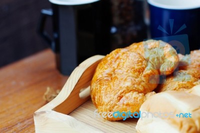Bread And Cup On Table Stock Photo