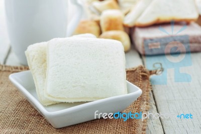 Bread In Plate On Wooden Stock Photo