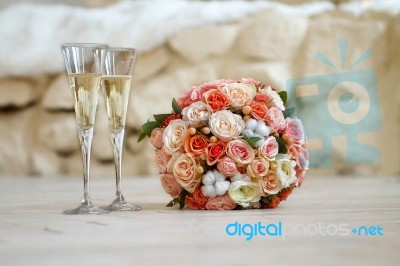Bridal Bouquet And Two Glasses Of Champagne Stock Photo