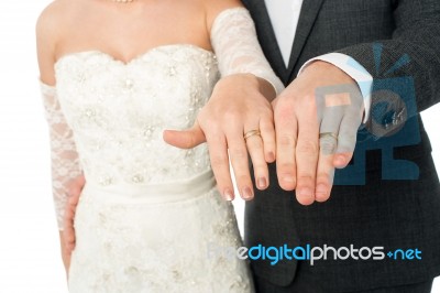 Bride And Groom Showing Their Wedding Rings Stock Photo
