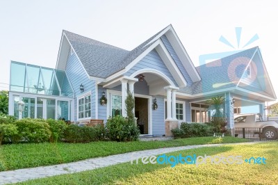 Bright Blue House In Sunlght With Colorful Poppies And Some Grac… Stock Photo