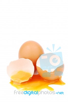 Broken Egg With The Yolk And White Oozing Out Stock Photo