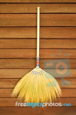 Broom On Wooden Wall Stock Photo