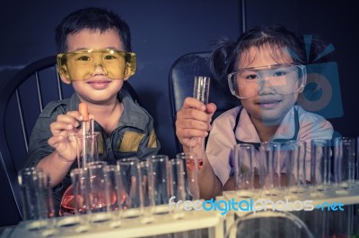Brother And Sister Studying In School Science Research Laboratory Stock Photo