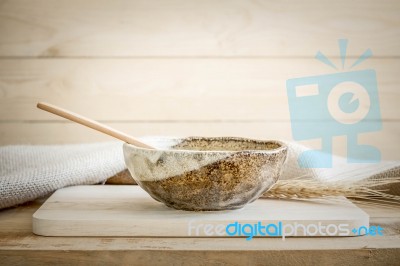 Brown Bowl With Spoon On Wooden Background Stock Photo