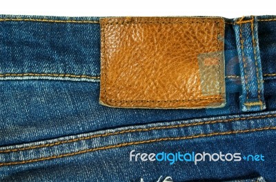 Brown Leather Label On Blue Jeans Stock Photo