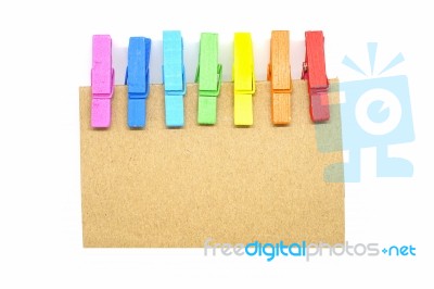 Brown Notepad With Colorful Clip On White Background Stock Photo
