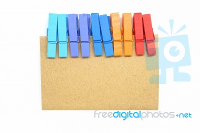 Brown Notepad With Colorful Clip On White Background Stock Photo