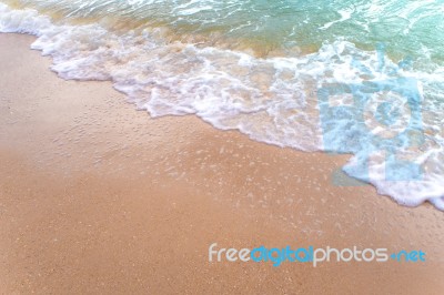 Bubble Of Sea Wave On Sand Stock Photo