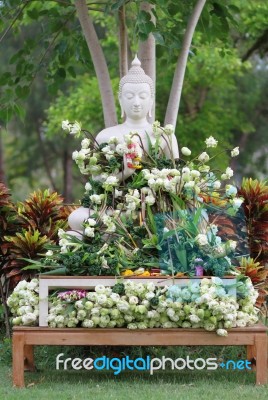 Buddhism Worship With Offering Flowers And Garland To Buddha Statue On Magha Puja, Asalha Puja And Visakha Puja Day In Thailand Stock Photo