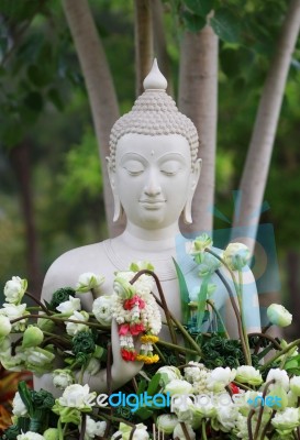 Buddhism Worship With Offering Flowers And Garland To Buddha Statue On Magha Puja, Asalha Puja And Visakha Puja Day In Thailand Stock Photo