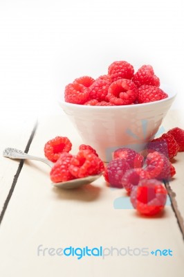 Bunch Of Fresh Raspberry On A Bowl And White Table Stock Photo