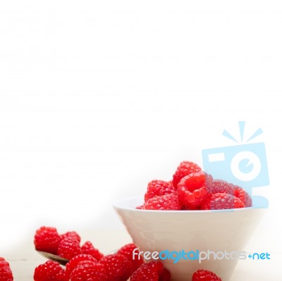 Bunch Of Fresh Raspberry On A Bowl And White Table Stock Photo