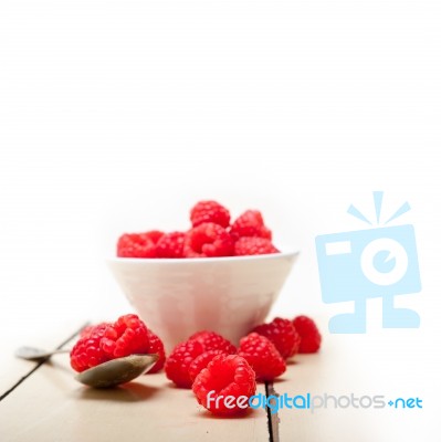 Bunch Of Fresh Raspberry On A Bowl And White Table Stock Photo