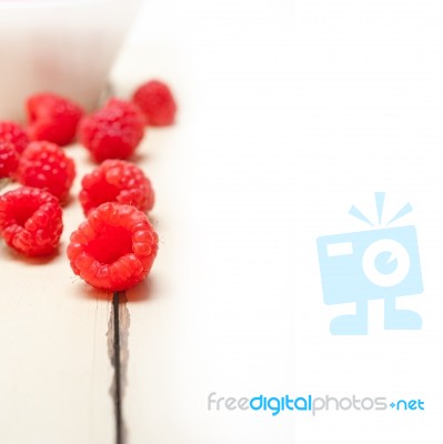 Bunch Of Fresh Raspberry On A Bowl And White Table Stock Photo