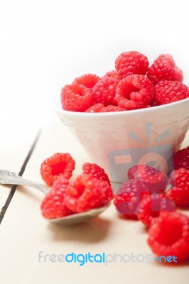 Bunch Of Fresh Raspberry On A Bowl And White Table Stock Photo