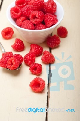 Bunch Of Fresh Raspberry On A Bowl And White Table Stock Photo