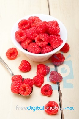 Bunch Of Fresh Raspberry On A Bowl And White Table Stock Photo