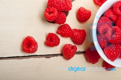 Bunch Of Fresh Raspberry On A Bowl And White Table Stock Photo