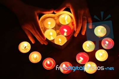 Burning Candle Heart Shape In Female Hands Stock Photo