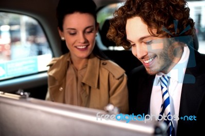 Business Colleagues Travelling Together In Taxi Cab Stock Photo