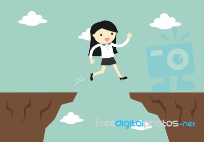 Business Concept, Business Woman Jump Through The Gap To Another Cliff Stock Image