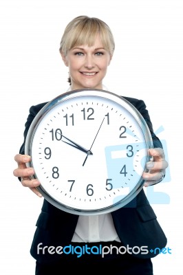 Business Executive Displaying Big Wall Clock Stock Photo