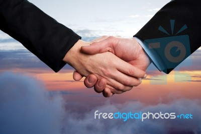 Business Handshake On A Sky Background Stock Photo Business Handshake On A Sky Background Stock Photo