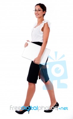 Business Lady Walking With Laptop Stock Photo
