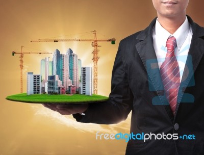 Business Man And Building Construction In Hand Stock Photo