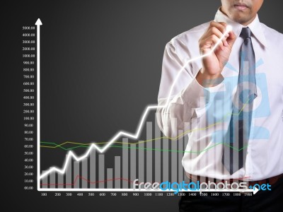 Business Man Hand Drawing A Graph Stock Photo