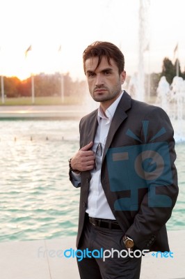 Business Man In Front Of A Fountain Stock Photo