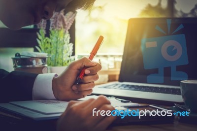 Business Man Sitting On A Calculator To Figure Out In A Coffee S… Stock Photo